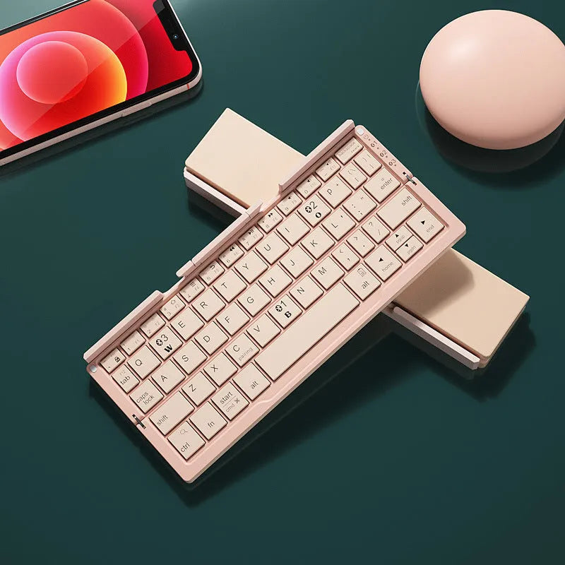 Silver white folding Bluetooth keyboard with hidden stand supporting smartphone, shown open and closed