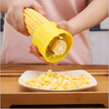 Yellow manual corn thresher kitchen tool with corn-shaped design and stainless steel gear