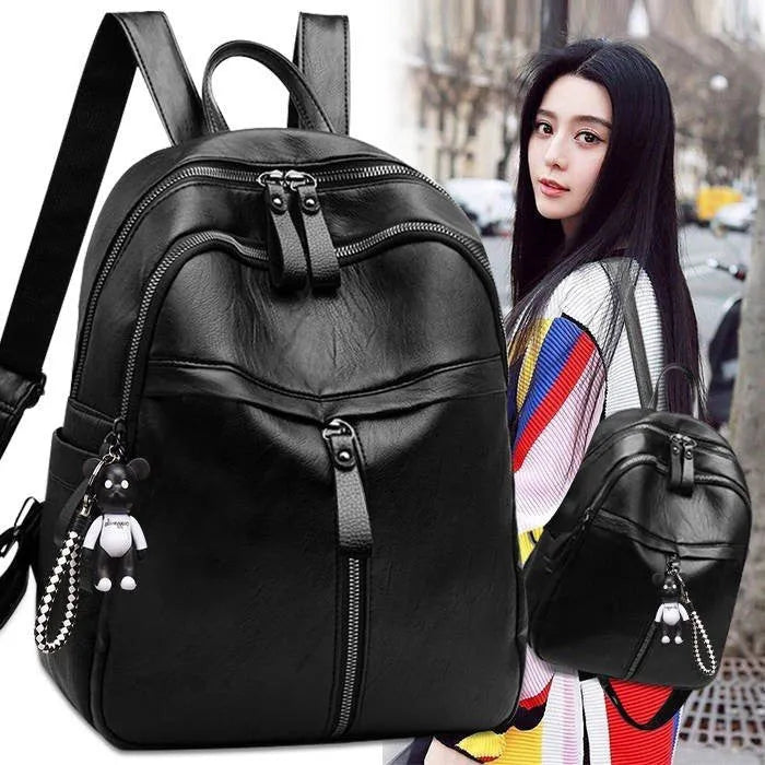 Black PU leather student backpack with double straps showing 20-35L capacity and organisational features
