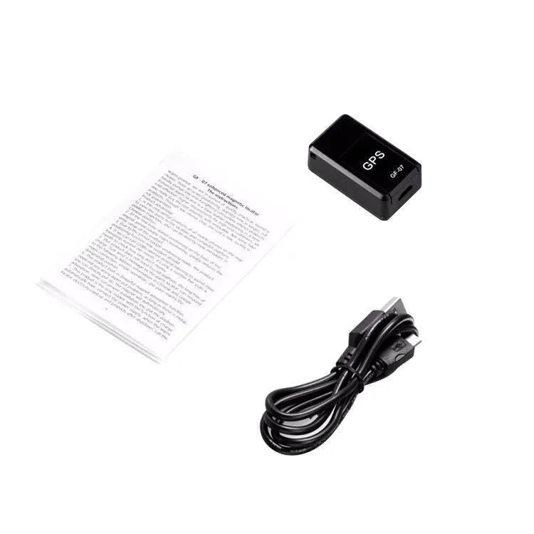 Black plastic magnetic GPS car tracker device measuring 35x20x14mm with USB charging cable