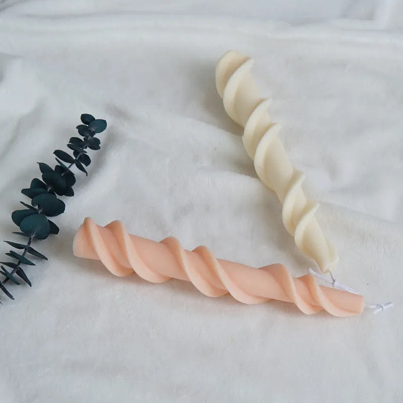 Silicone spiral lace rod candle mould for making decorative pillar candles.