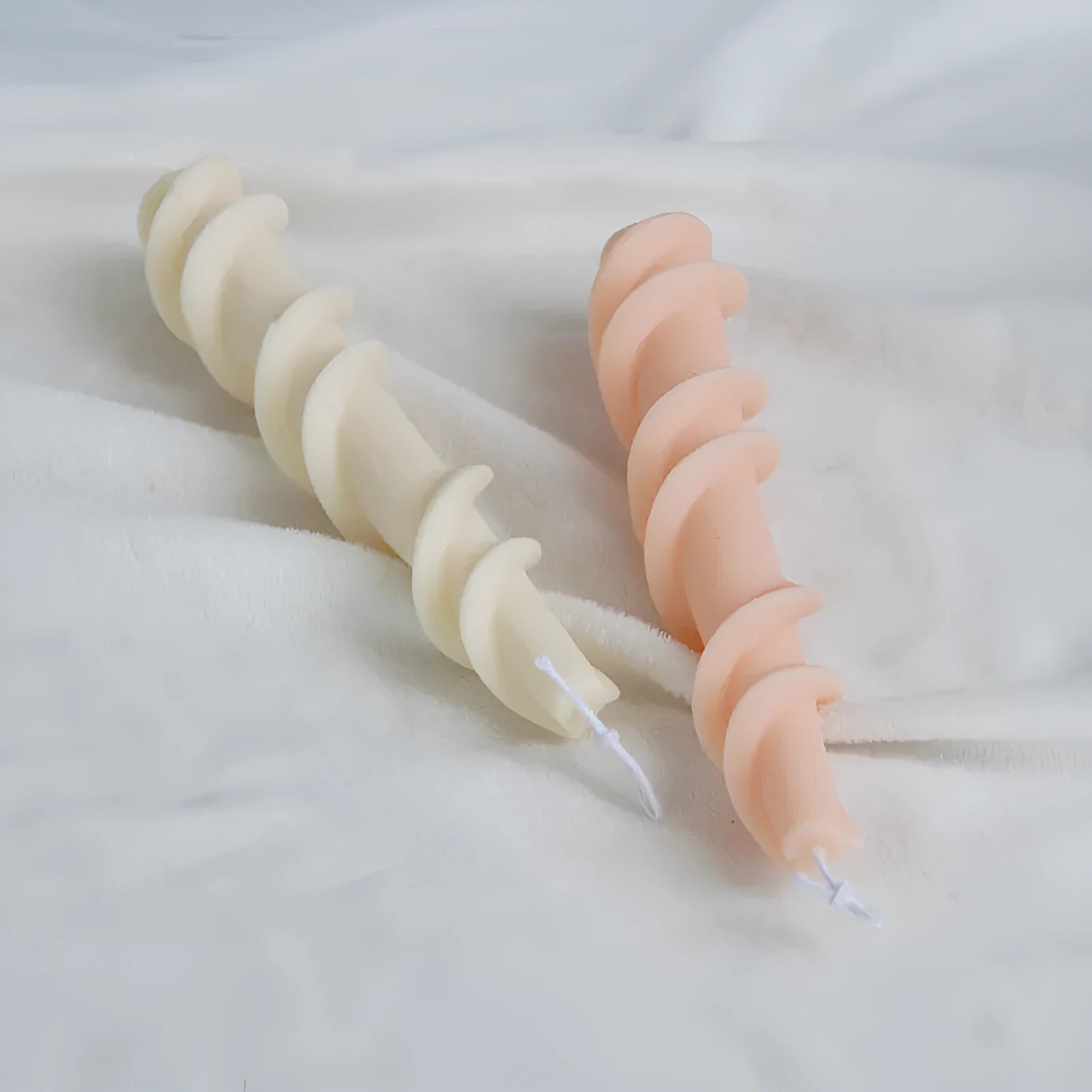 Silicone spiral lace rod candle mould for making decorative pillar candles.
