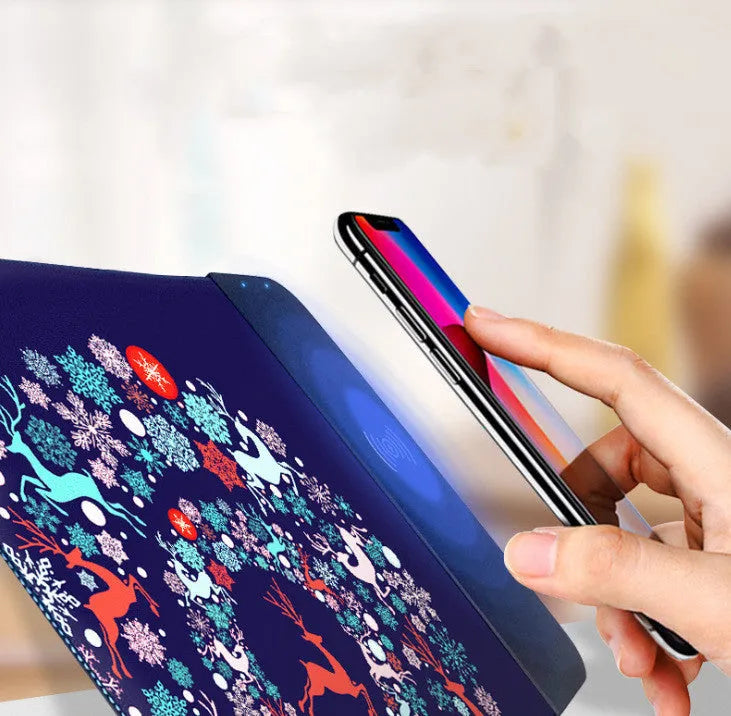Cartoon pattern wireless charging mouse pad with RGB lighting showing smartphone charging on surface