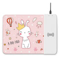 Cartoon pattern wireless charging mouse pad with RGB lighting showing smartphone charging on surface