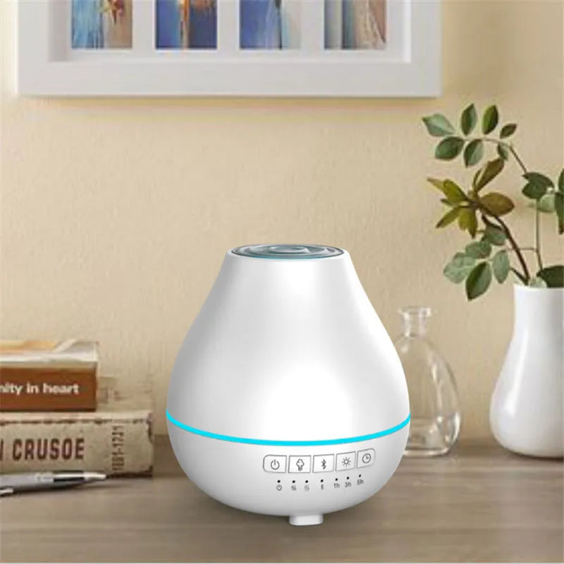 Round white Bluetooth humidifier and essential oil diffuser with night light on wooden surface