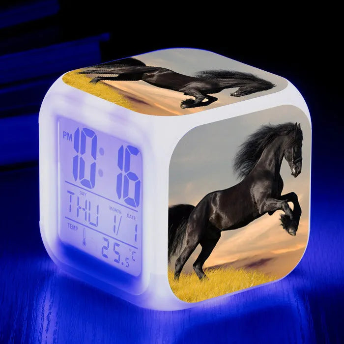 Small square plastic LED alarm clock showing time and temperature on its display.