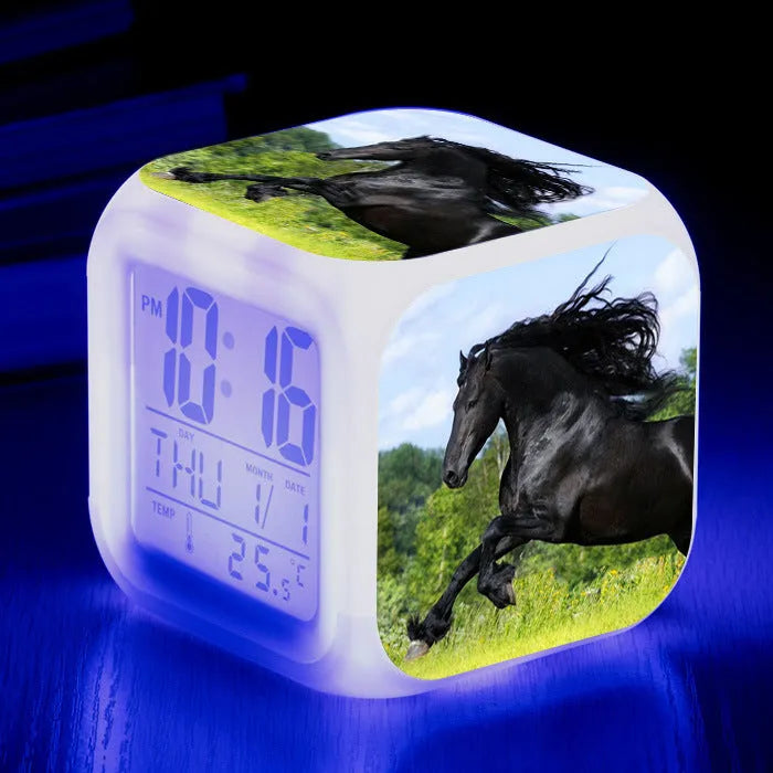 Small square plastic LED alarm clock showing time and temperature on its display.