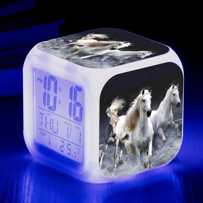 Small square plastic LED alarm clock showing time and temperature on its display.