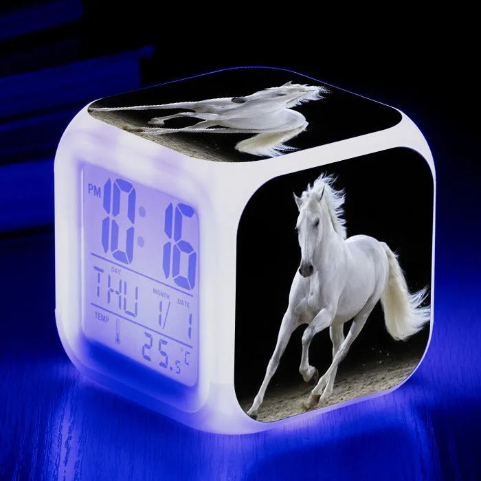 Small square plastic LED alarm clock showing time and temperature on its display.