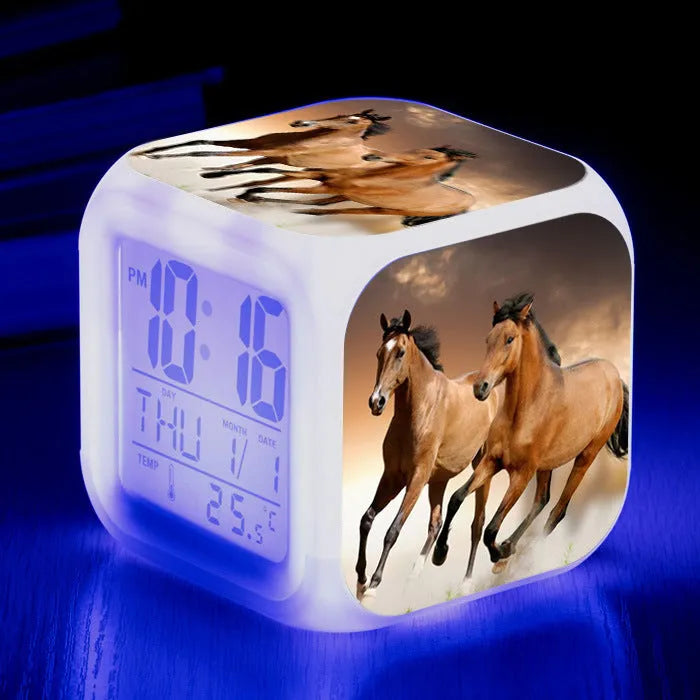 Small square plastic LED alarm clock showing time and temperature on its display.