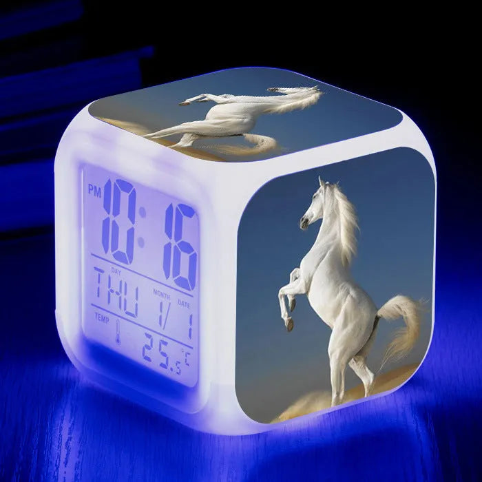 Small square plastic LED alarm clock showing time and temperature on its display.