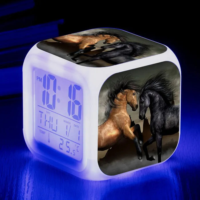 Small square plastic LED alarm clock showing time and temperature on its display.