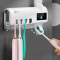 Smart UV toothbrush steriliser with automatic toothpaste dispenser wall mounted in bathroom
