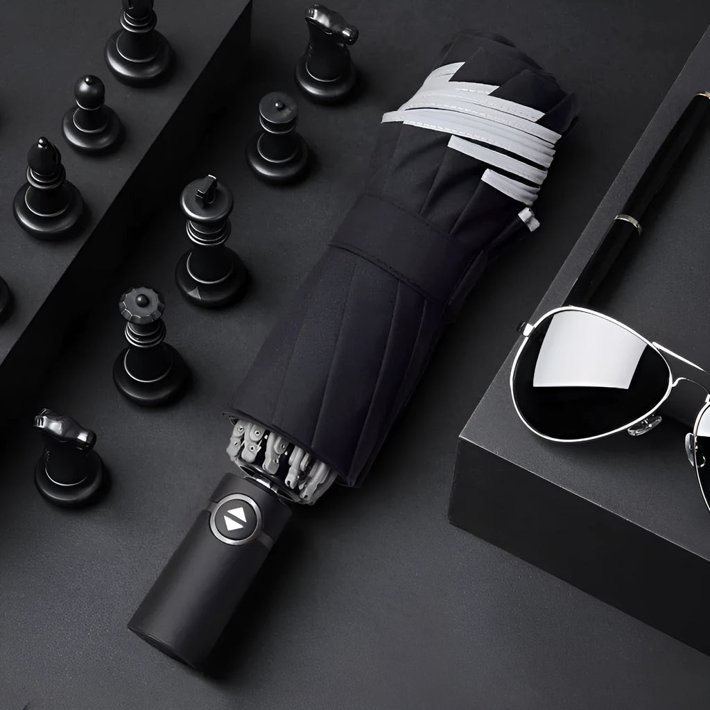 Black automatic reverse folding umbrella shown open, demonstrating its 10-rib canopy structure and plastic non-slip handle.