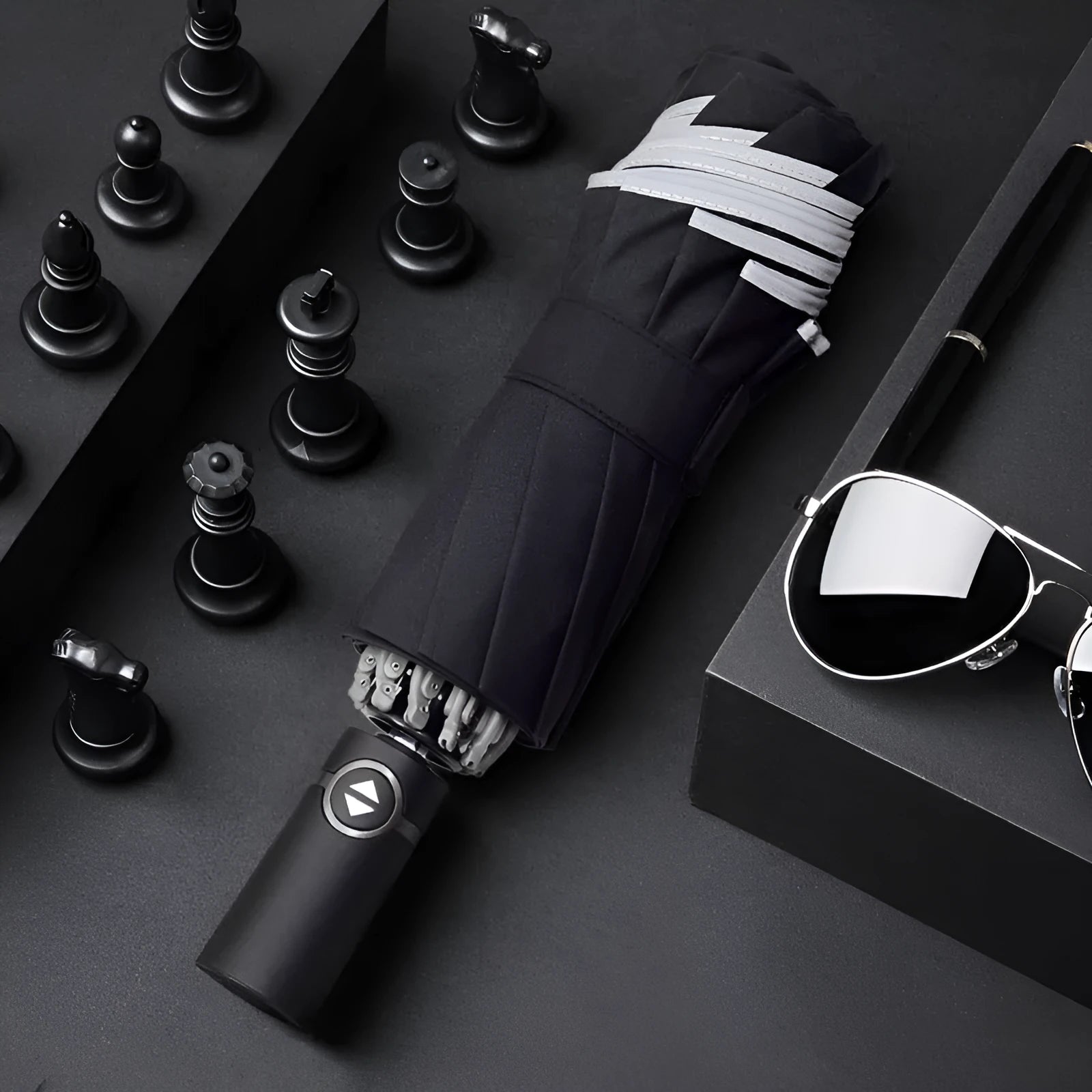 Black automatic reverse folding umbrella shown open, demonstrating its 10-rib canopy structure and plastic non-slip handle.