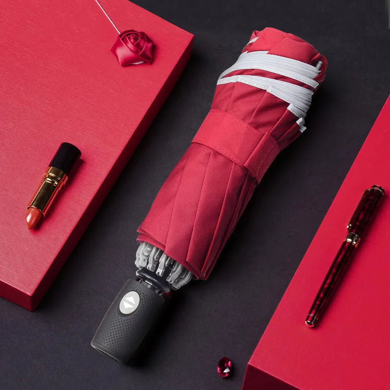 Black automatic reverse folding umbrella shown open, demonstrating its 10-rib canopy structure and plastic non-slip handle.
