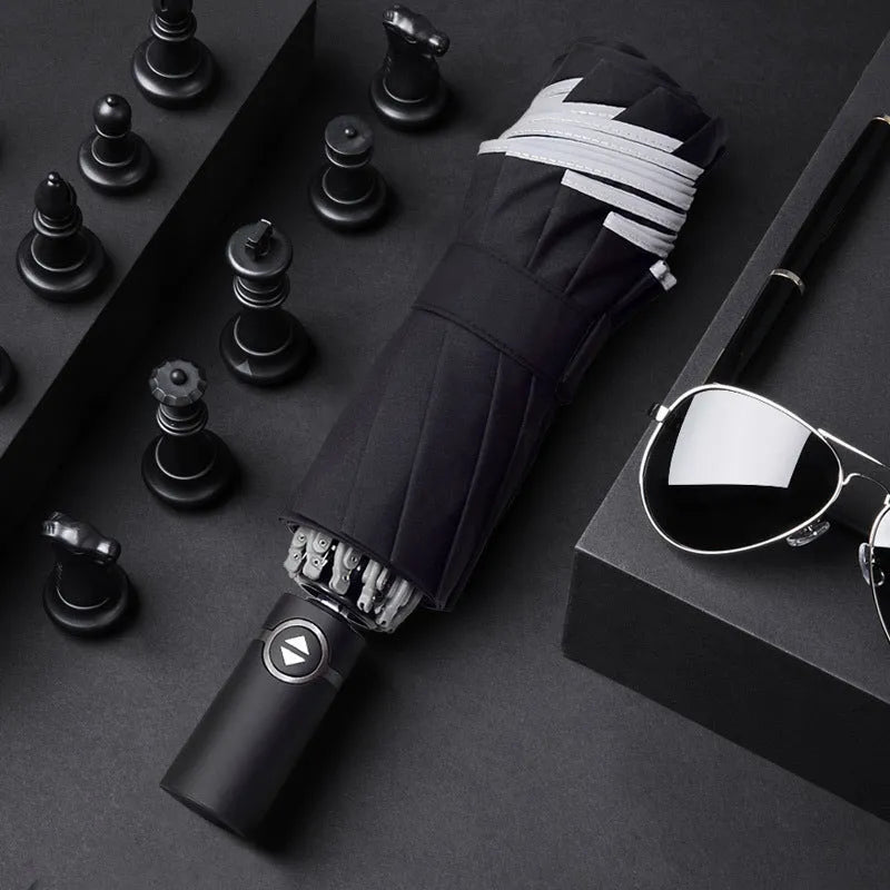 Black automatic reverse folding umbrella shown open, demonstrating its 10-rib canopy structure and plastic non-slip handle.