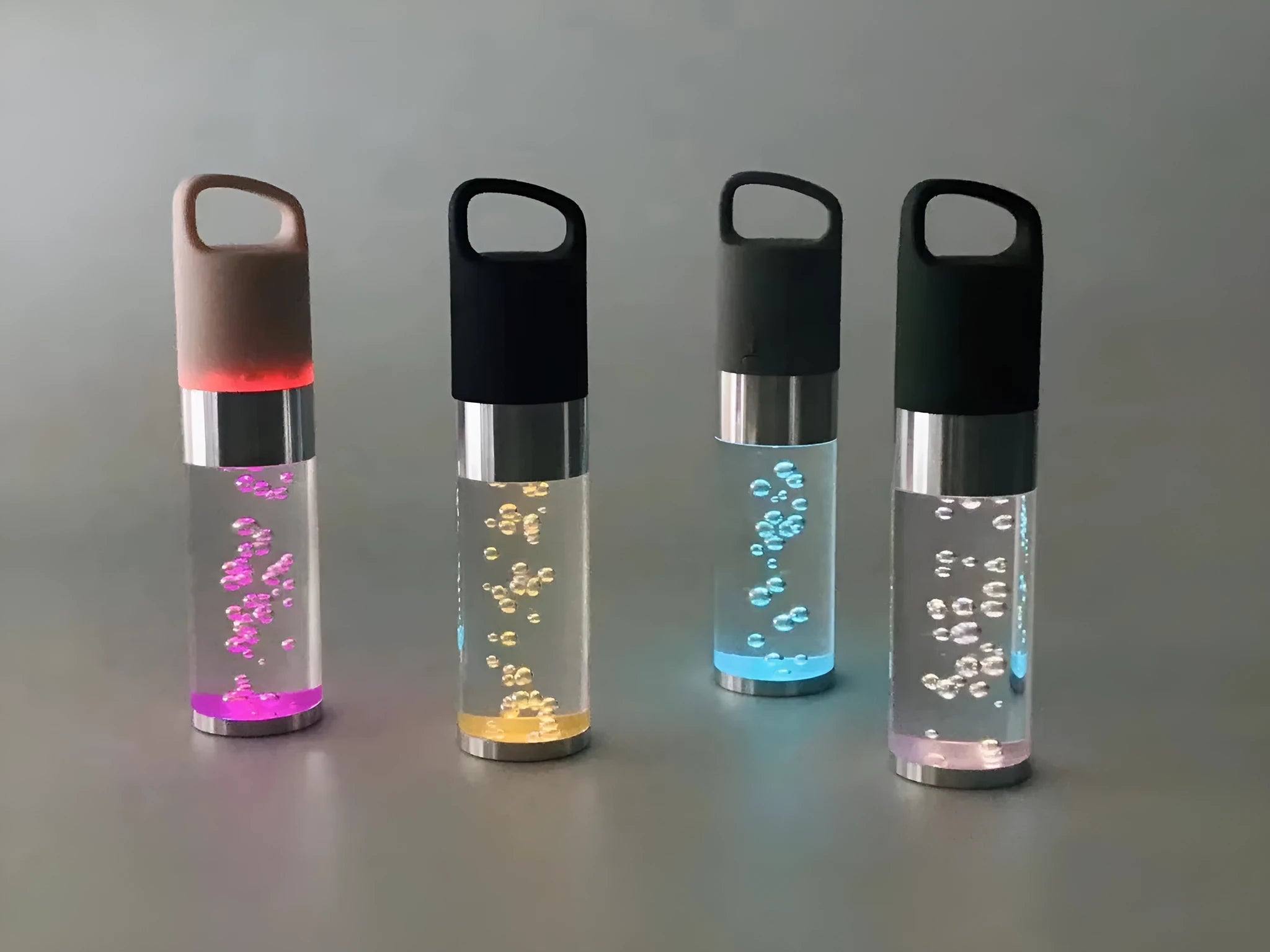 Compact colourful Bluetooth speaker with crystal light feature in pink, black, silver, or green.