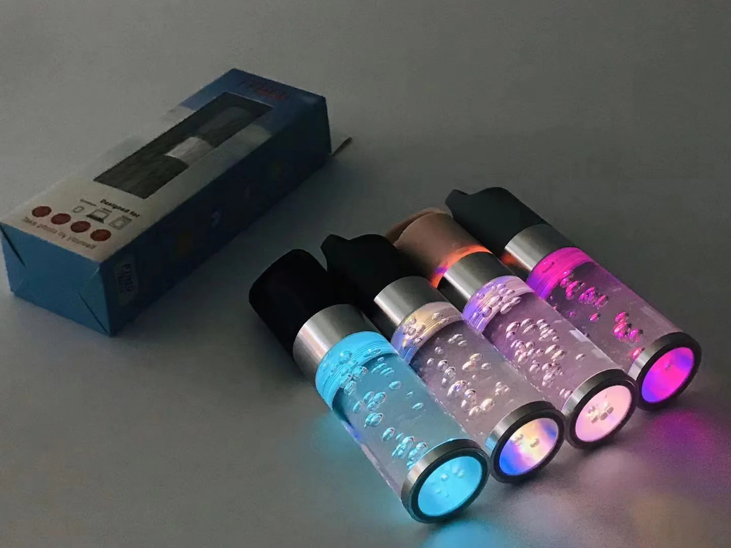 Compact colourful Bluetooth speaker with crystal light feature in pink, black, silver, or green.