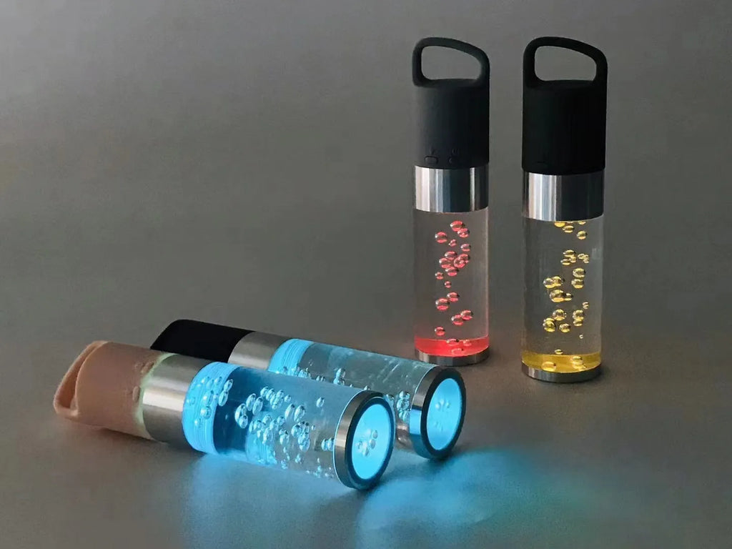 Compact colourful Bluetooth speaker with crystal light feature in pink, black, silver, or green.