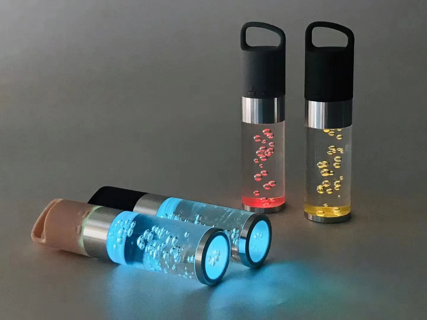 Compact colourful Bluetooth speaker with crystal light feature in pink, black, silver, or green.