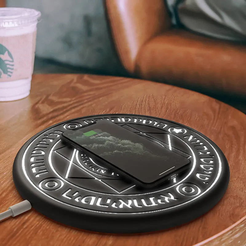 Square wireless phone charger with magic array pattern showing black colour option on desk surface