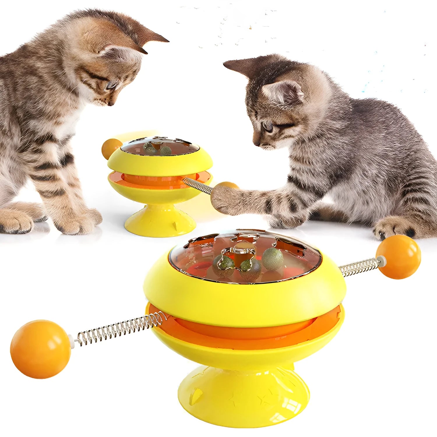 Rotatable cat toy with colourful turntable, stick elements, and transparent top holding catnip balls on a suction cup base.