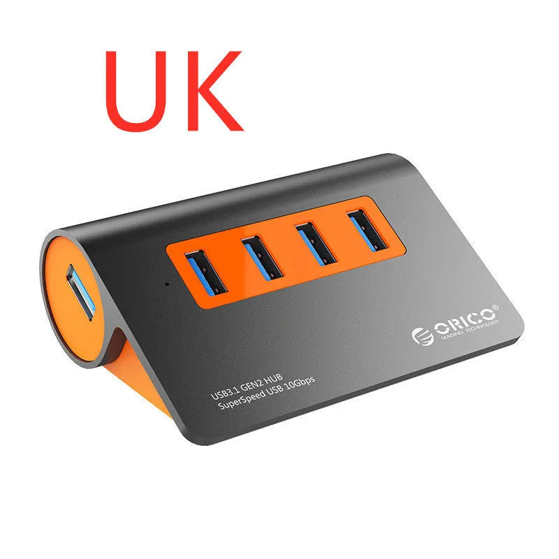 Dark grey USB-C laptop hub with four orange-accented USB 3.1 ports and separate data cable