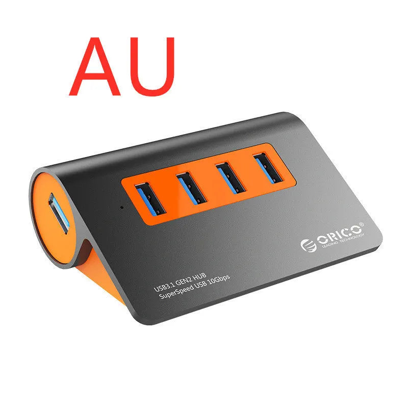 Dark grey USB-C laptop hub with four orange-accented USB 3.1 ports and separate data cable