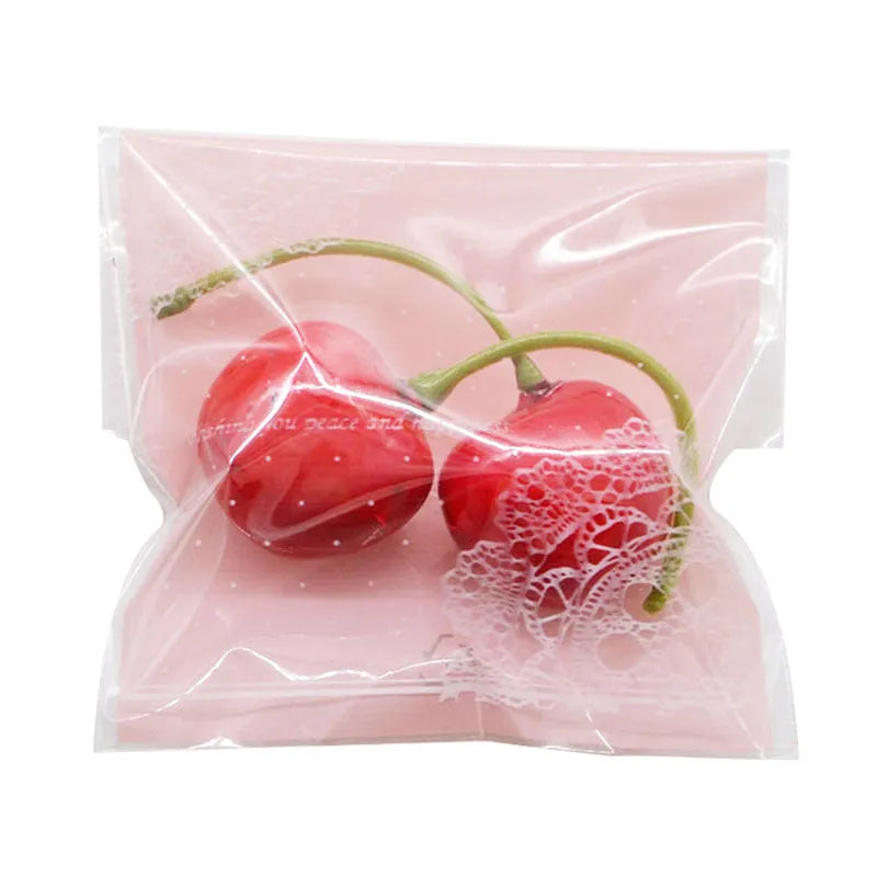 Pink self-adhesive plastic packaging bags for handmade soap, showing size and gusset