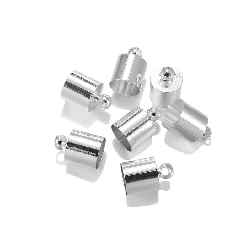 Assortment of small, shiny copper weight caps in various sizes and metallic colours for jewellery making.