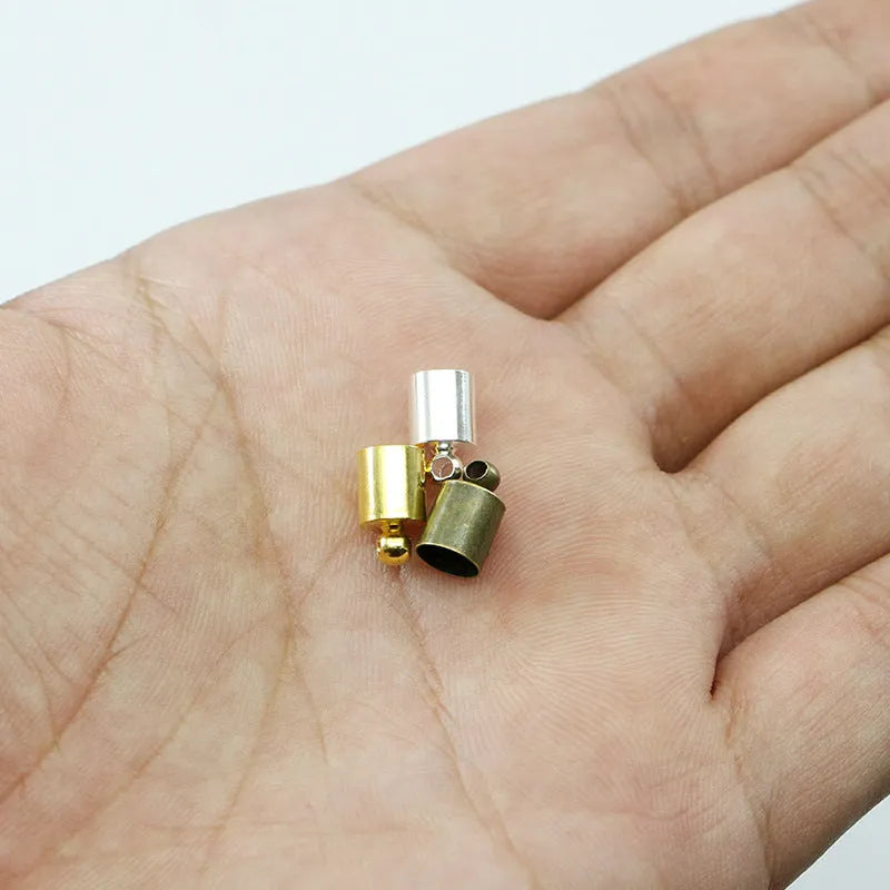 Assortment of small, shiny copper weight caps in various sizes and metallic colours for jewellery making.