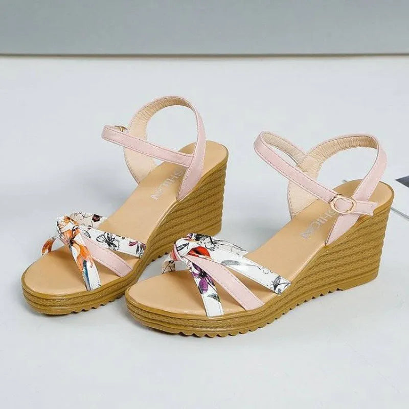 Women's pink wedge sandals with thick heel and fish mouth opening showing adjustable buckle closure