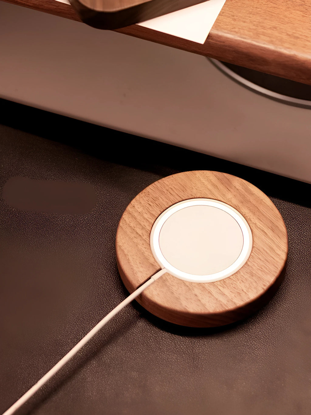 Solid walnut wood magnetic wireless charging bracket base for Magsafe iPhones on a desktop.