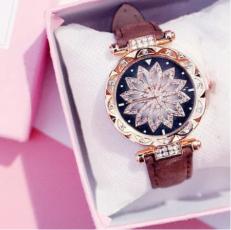 Women's fashion watch with diamond bezel, round 32mm dial, available in multiple colours on a pin buckle strap.