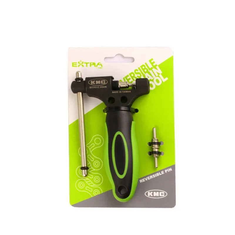 Green steel bicycle chain cutter with a double shaft device and a separate chain driver on a workbench.