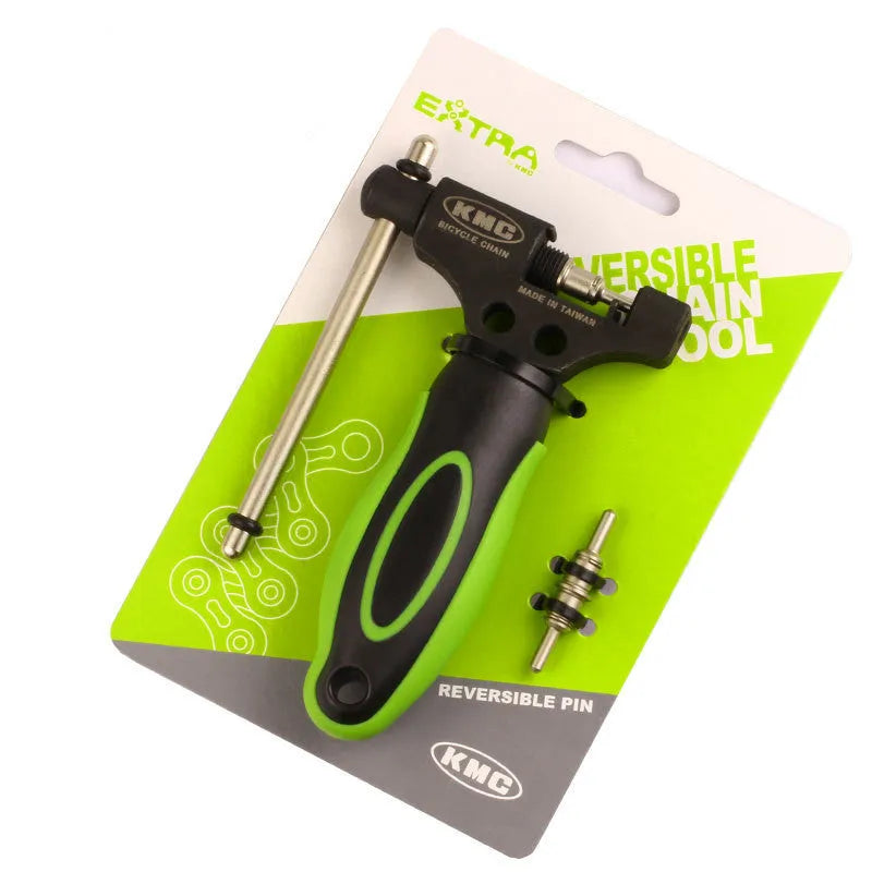 Green steel bicycle chain cutter with a double shaft device and a separate chain driver on a workbench.