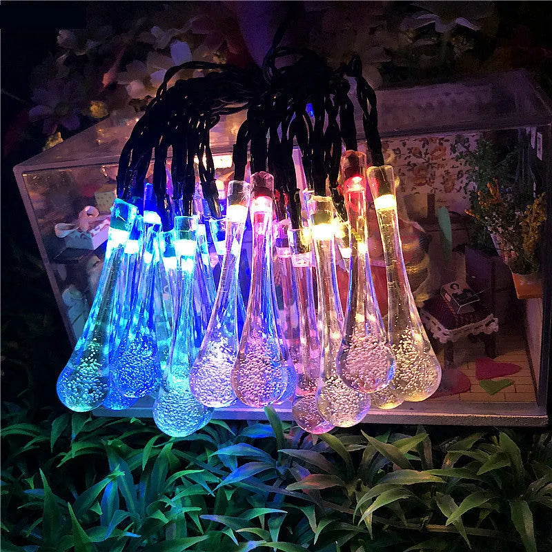 Solar-powered LED Water Drops string lights with ABS plastic pendants on a 6.5 metre wire for outdoor gardens.