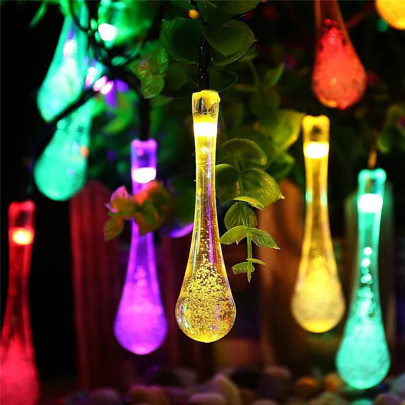 Solar-powered LED Water Drops string lights with ABS plastic pendants on a 6.5 metre wire for outdoor gardens.