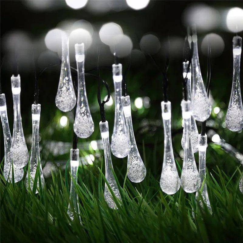 Solar-powered LED Water Drops string lights with ABS plastic pendants on a 6.5 metre wire for outdoor gardens.