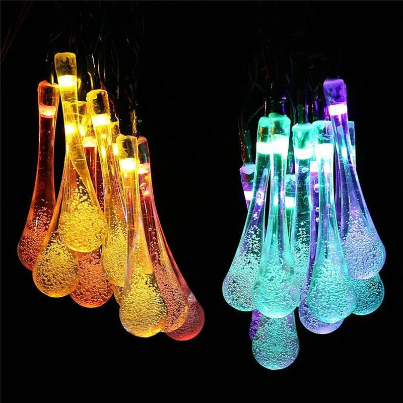 Solar-powered LED Water Drops string lights with ABS plastic pendants on a 6.5 metre wire for outdoor gardens.