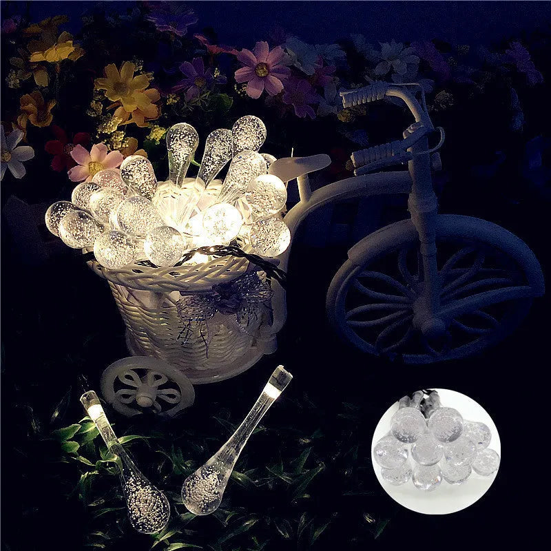 Solar-powered LED Water Drops string lights with ABS plastic pendants on a 6.5 metre wire for outdoor gardens.