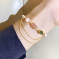 Women's pink freshwater pearl bracelet with geometric design and strawberry crystal charm