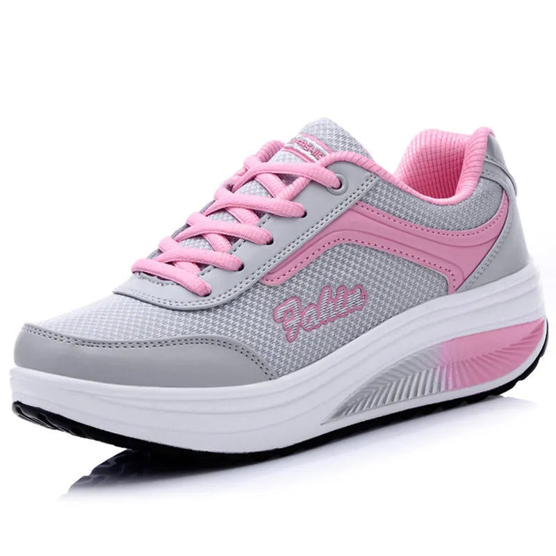 Women's grey powder mid-heel sports shoes for travel, shown from the side.
