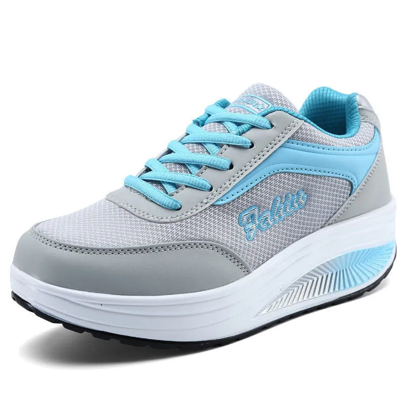 Women's grey powder mid-heel sports shoes for travel, shown from the side.