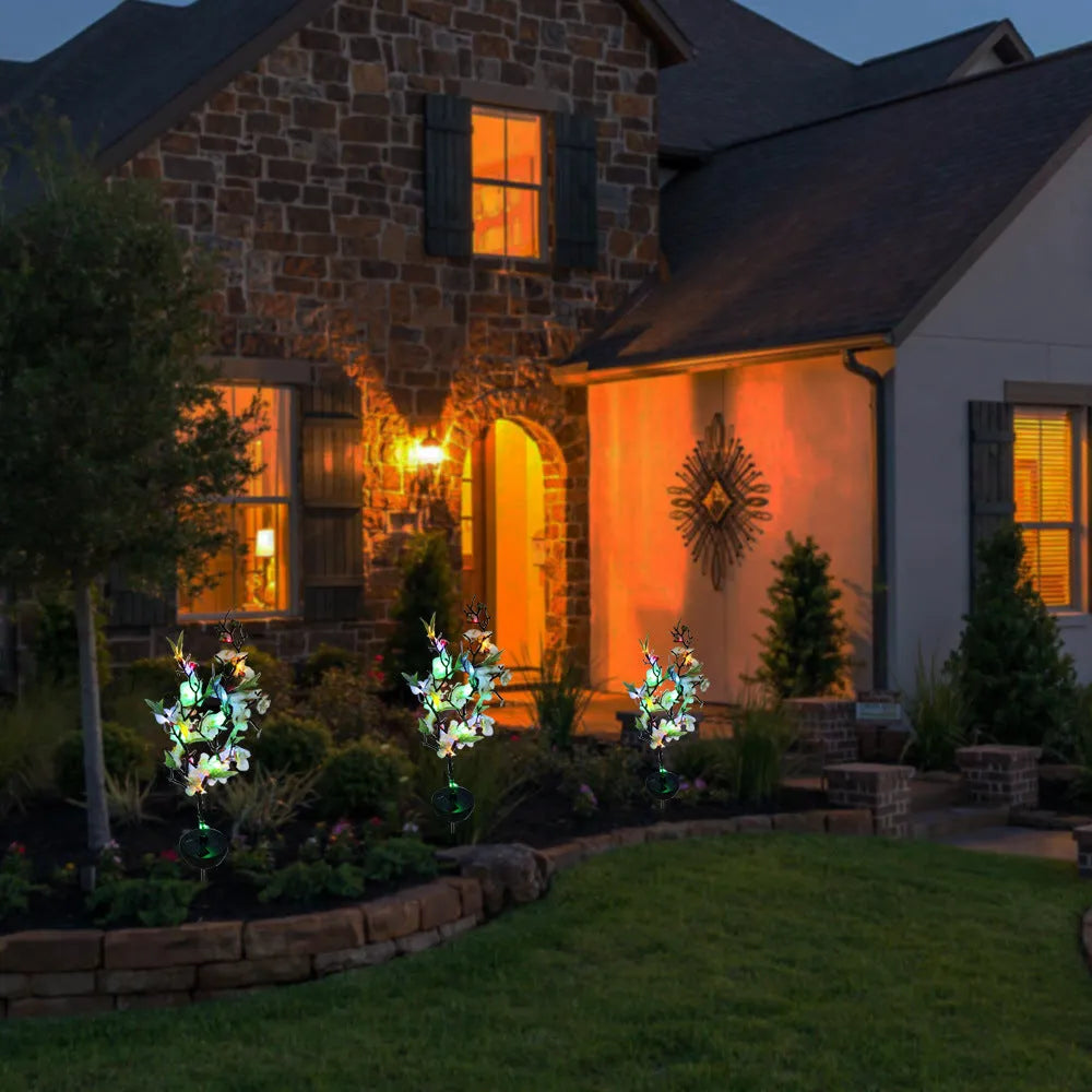 Solar-powered cherry blossom string lights with ground spike for outdoor garden decoration
