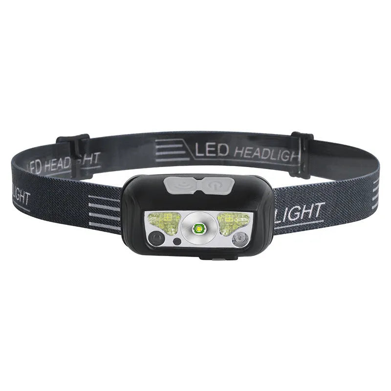 Black or blue LED sensor headlight with red running lights, shown with USB charging cable.