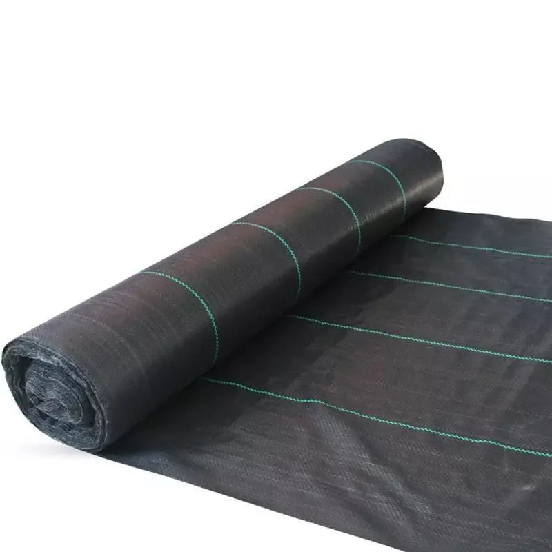 Black polyethylene weed-proof cloth laid on soil for farmland and garden weed suppression.