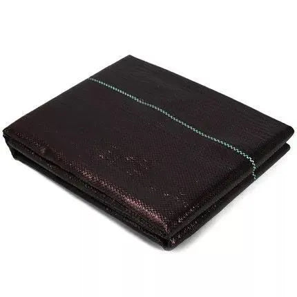Black polyethylene weed-proof cloth laid on soil for farmland and garden weed suppression.