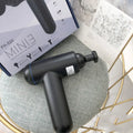 Grey fascia gun muscle massager with USB charging port for percussive therapy